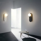 Nordic globe wall sconce with oval backplate