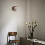 Round wooden wall light with frosted globe