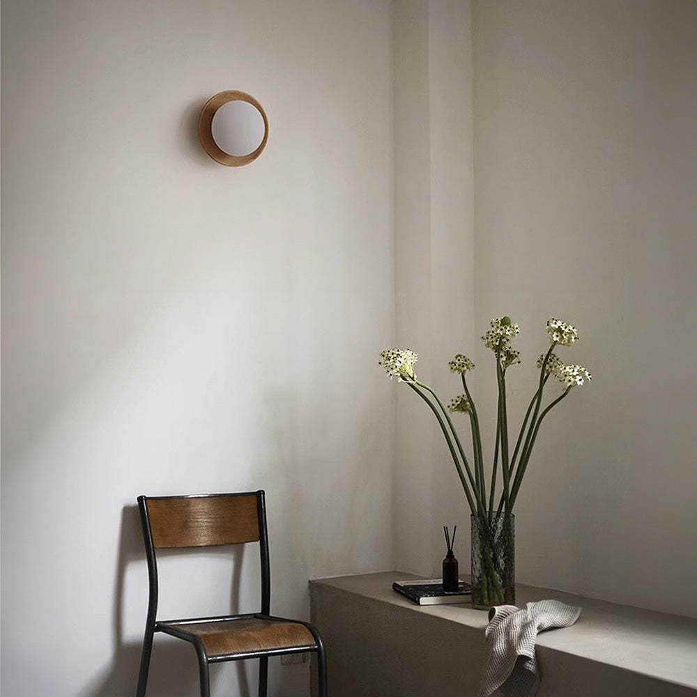 Round wooden wall light with frosted globe